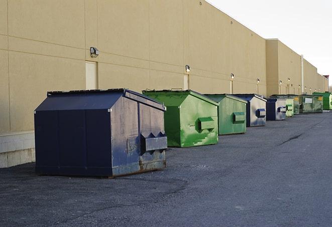 a construction worker moves construction materials near a dumpster in Borrego Springs, CA